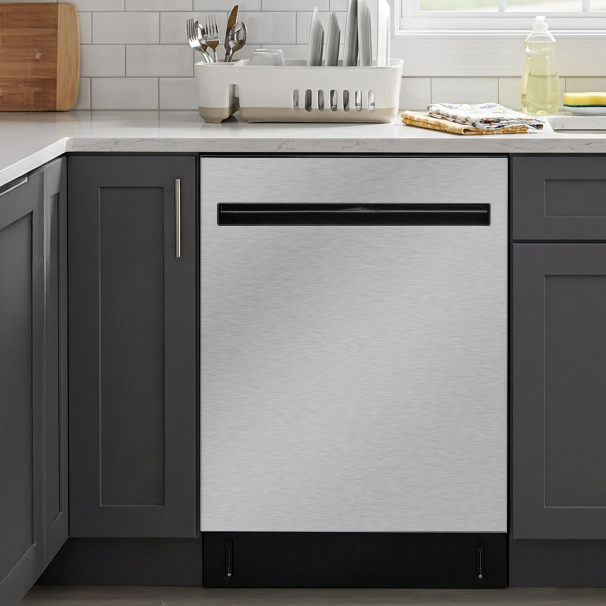 Kenmore ultra-quiet 24-inch top control dishwasher installed in a bright kitchen between dark grey cabinets.