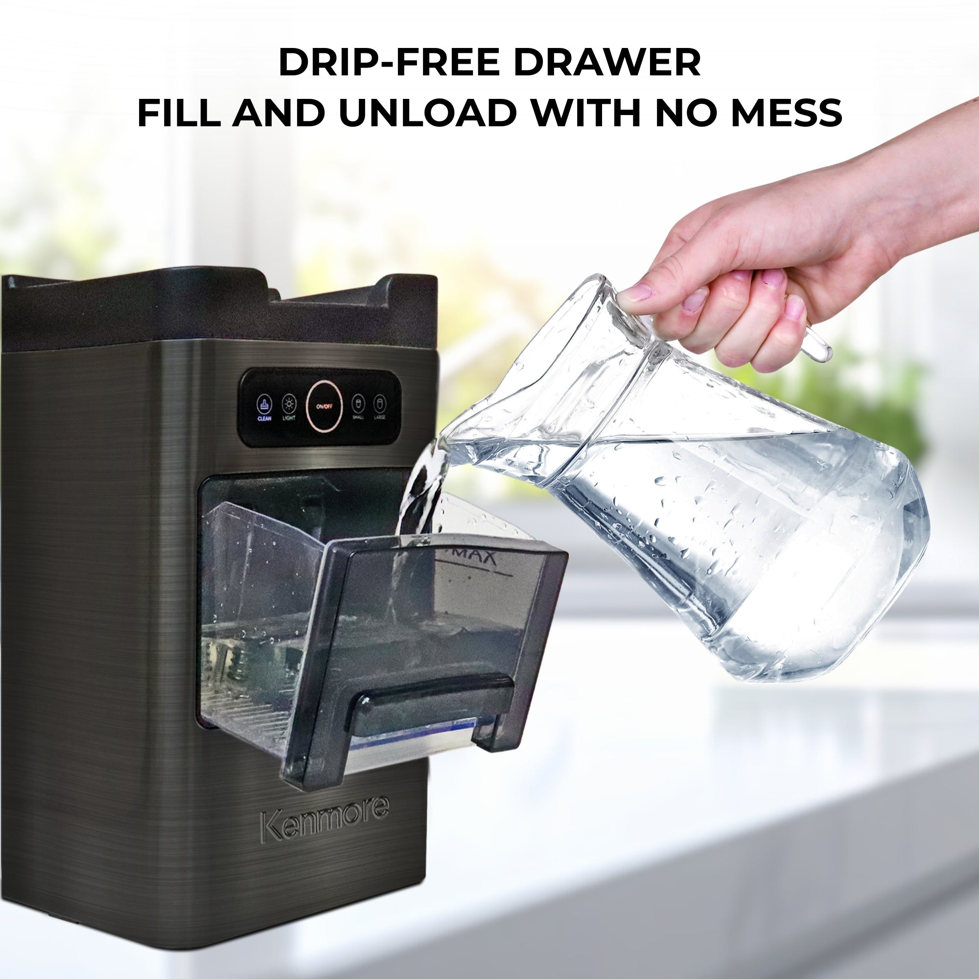 Kenmore front-load bullet ice maker on a grey speckled granite countertop with a person's hand pouring water from a pitcher into the ice/water drawer. Text above reads, "Drip-free drawer: fill and unload with no mess."