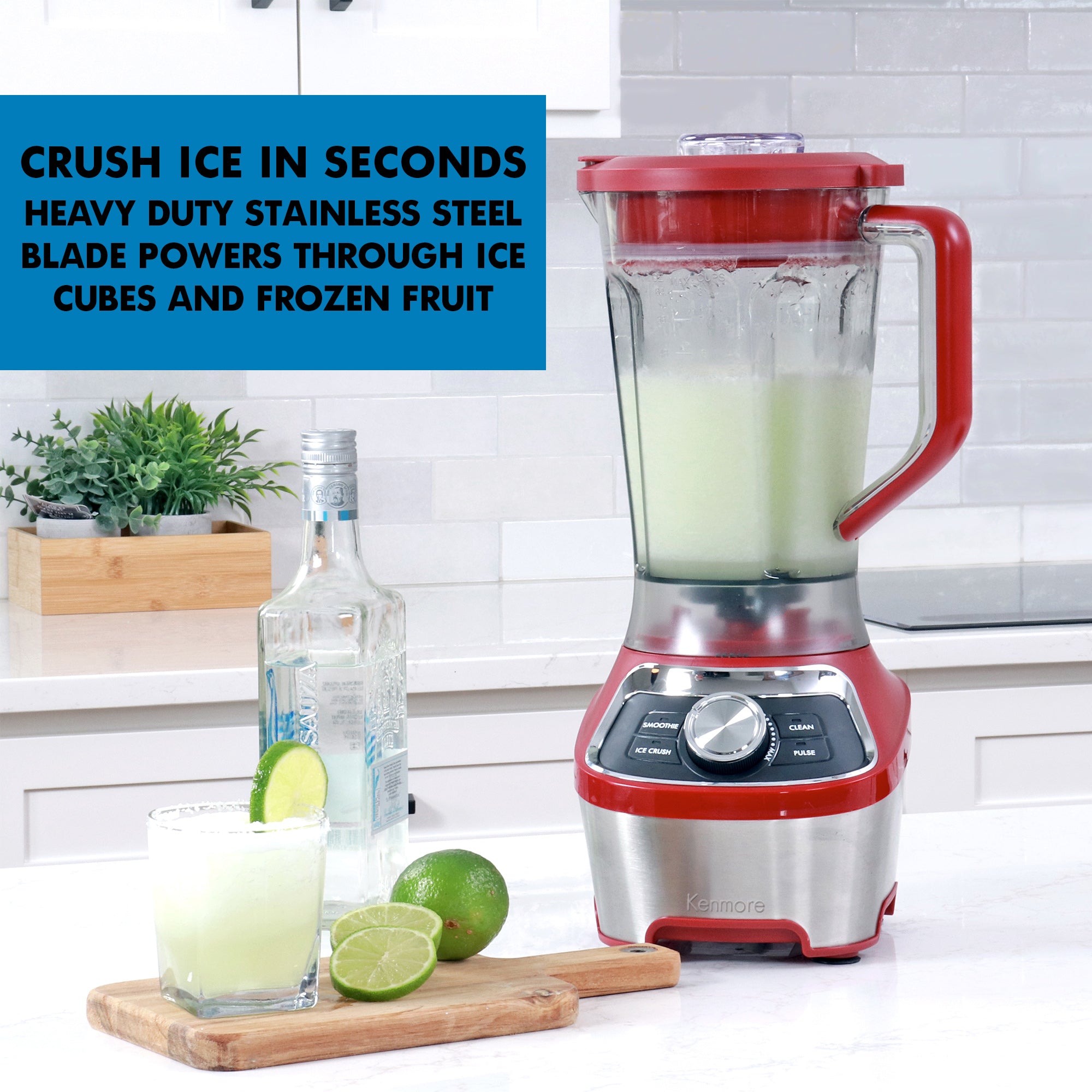 1.9 liter capacity blender filled with a light green frozen beverage on a white kitchen counter with a clear glass bottle and sliced lime and a glass of frozen blended margarita with a salted rim on a wooden cutting board beside it. Text overlay reads Crush ice in seconds: Heavy duty stainless steel blade powers through ice cubes and frozen fruit.