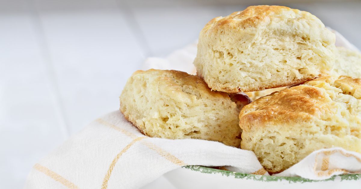 Photo of 3 fluffy biscuits stacked together on a plate