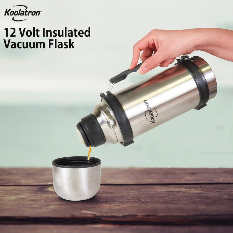 Lifestyle image of a person's hand holding the vacuum flask by its handle and pouring coffee into the single serve cup lid. The cup is sitting on a dark brown wood surface and the background is light blue. Text overlay reads Koolatron 12 Volt insulated vacuum flask.