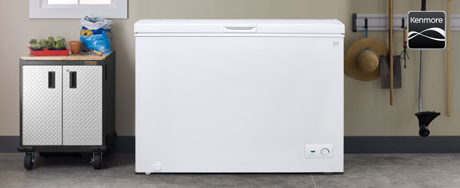 Kenmore 8.7 cubic foot chest freezer in a garage with gardening supplies on either side