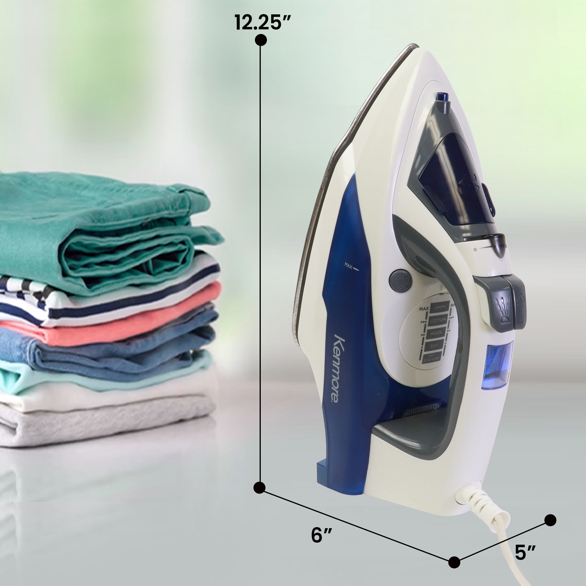 Kenmore digital power steam iron with dimensions labeled beside a pile of neatly folded clothing