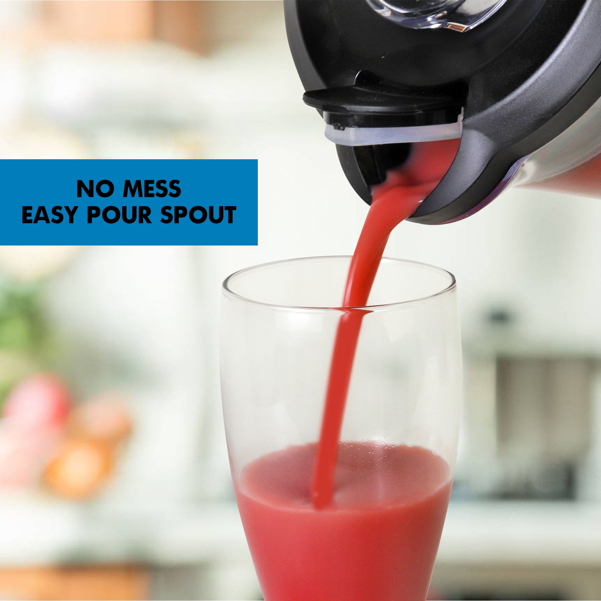 Closeup of bright pink smoothie pouring out of the blender's flip-top spout into a glass with text overlay reading No mess easy pour spout.