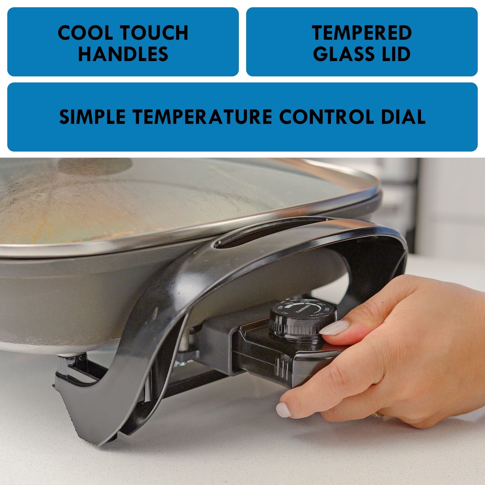 A person’s hand touching the temperature control dial on the side of the Kenmore non-stick electric skillet with glass lid with features listed above: Cool touch handles; tempered glass lid; simple temperature control dial.