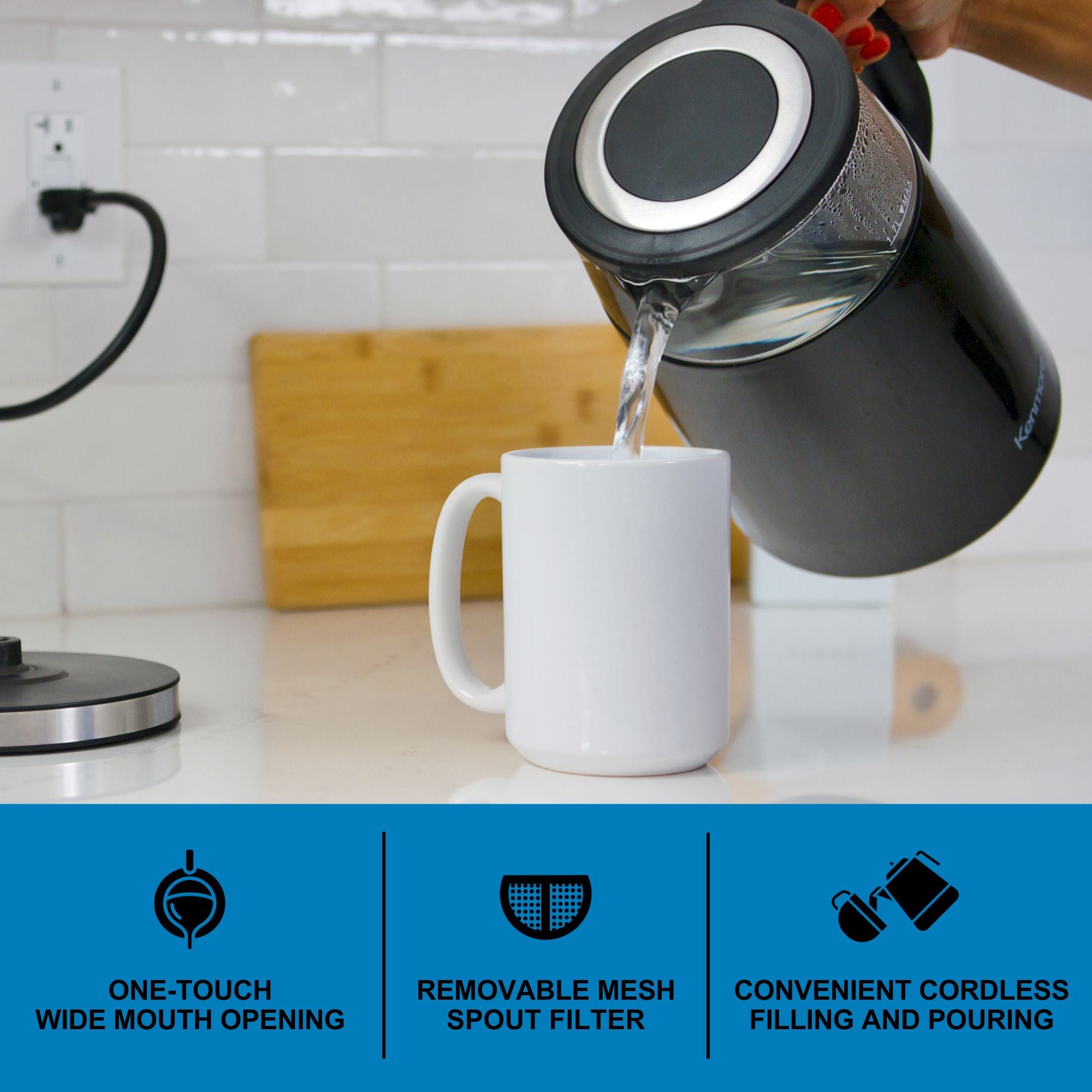 A person's hand holding the Kenmore programmable glass kettle and pouring hot water into a white mug. Text and icons below describe features: One-touch wide mouth opening; removable mesh spout filter; convenient cordless filling and pouring