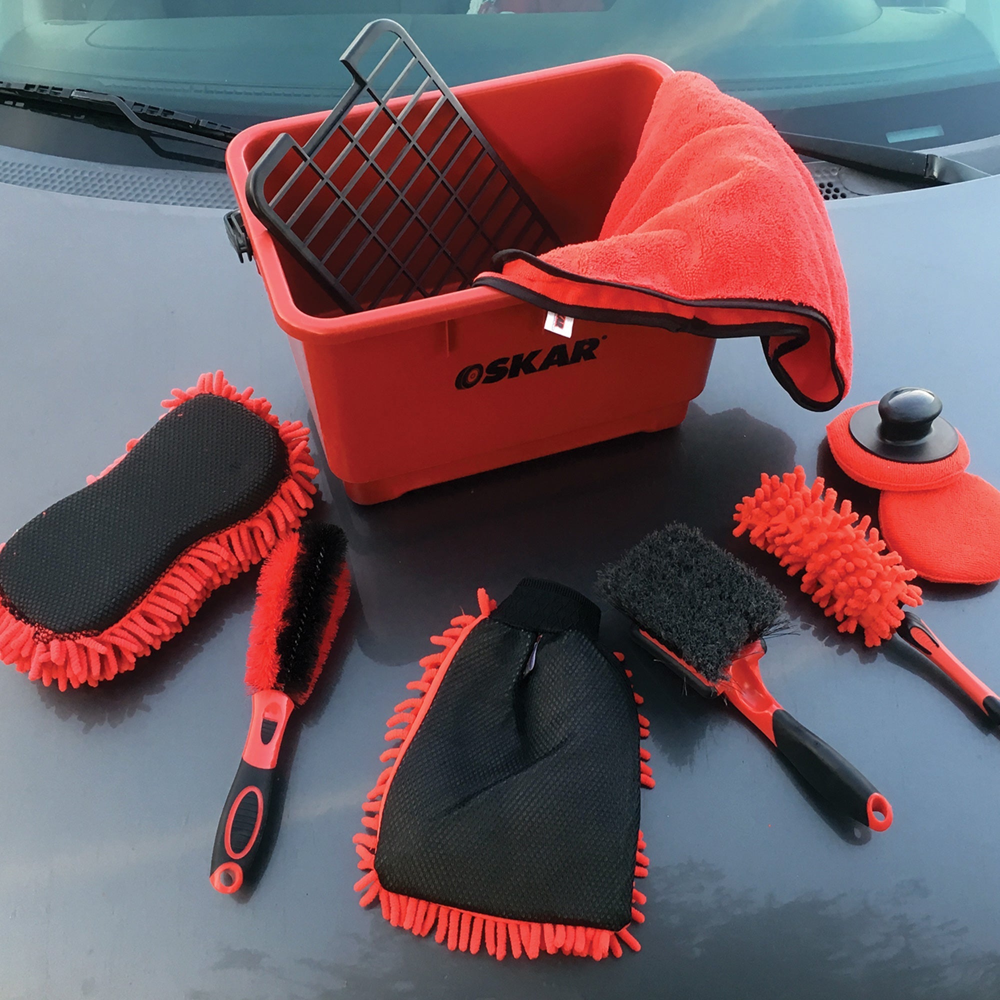 Lifestyle image of ultimate car wash kit showing all items laid out on the hood of a black vehicle