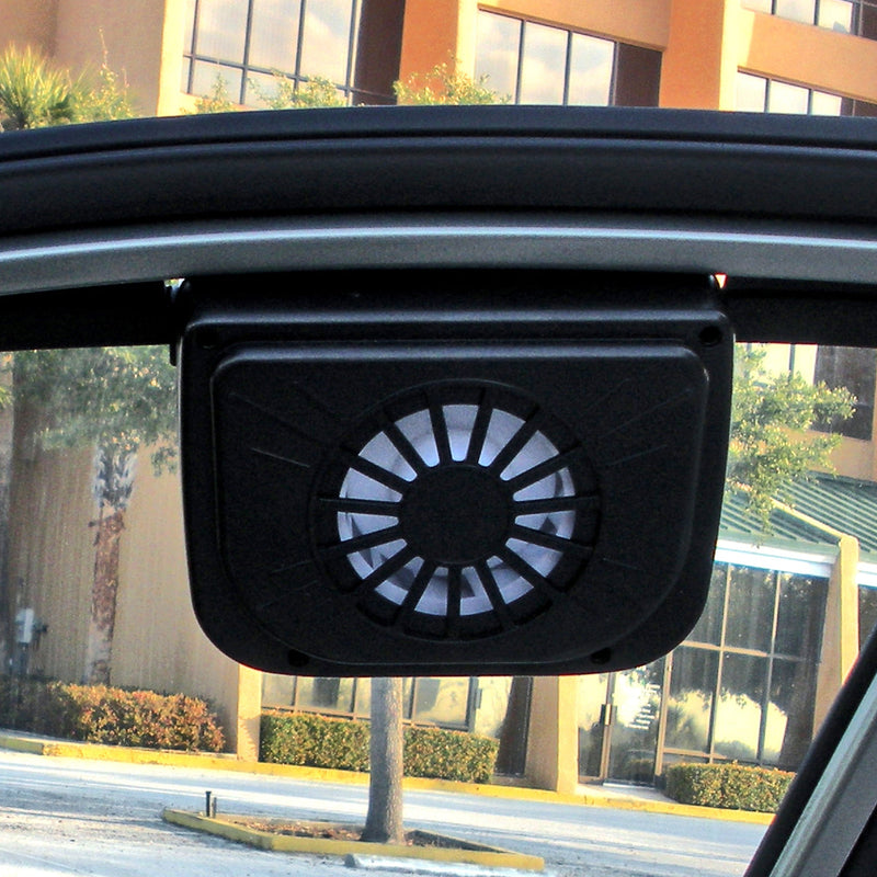Lifestyle image of the AutoKool vehicle vent system mounted on a car window viewed from inside