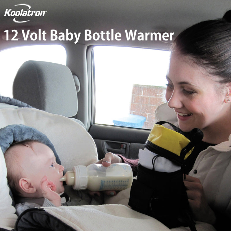 Lifestyle image of a person with light skin and brown hair in a ponytail feeding a bottle of milk to an infant with light skin sitting in a car seat. Text overlay reads, "Koolatron 12V baby bottle warmer"