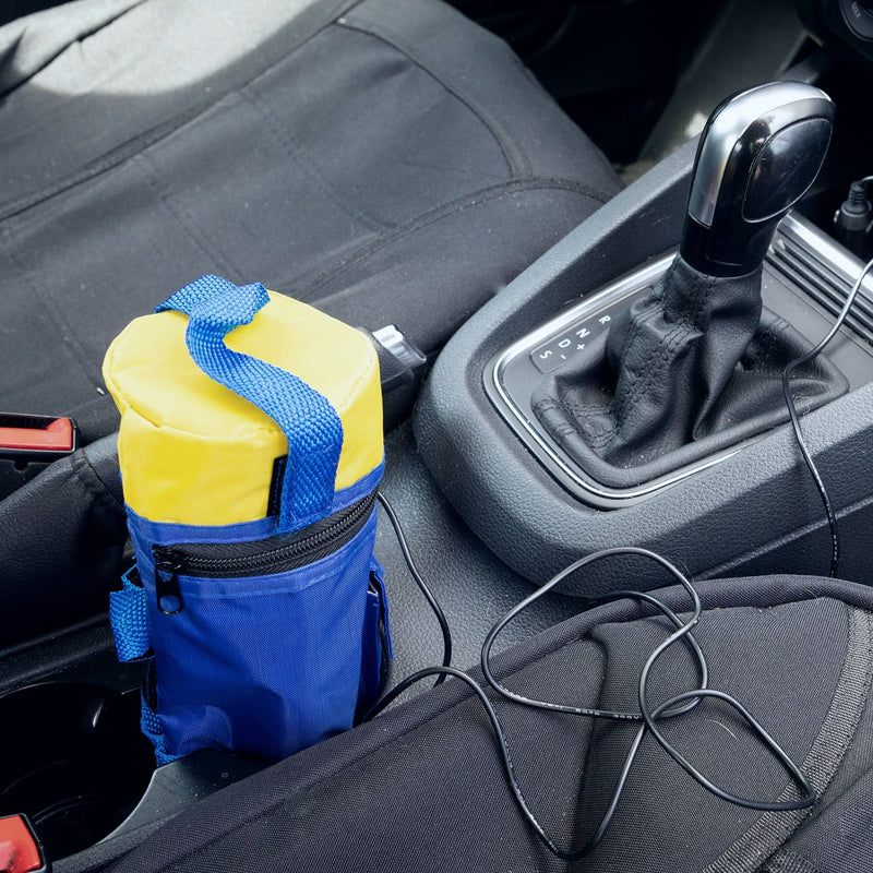 Lifestyle image of 12V baby bottle warmer in the cup holder of a vehicle with a dark gray interior