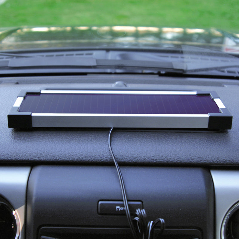 Lifestyle image of 1.9W solar trickle charger mounted on the a car's dashboard