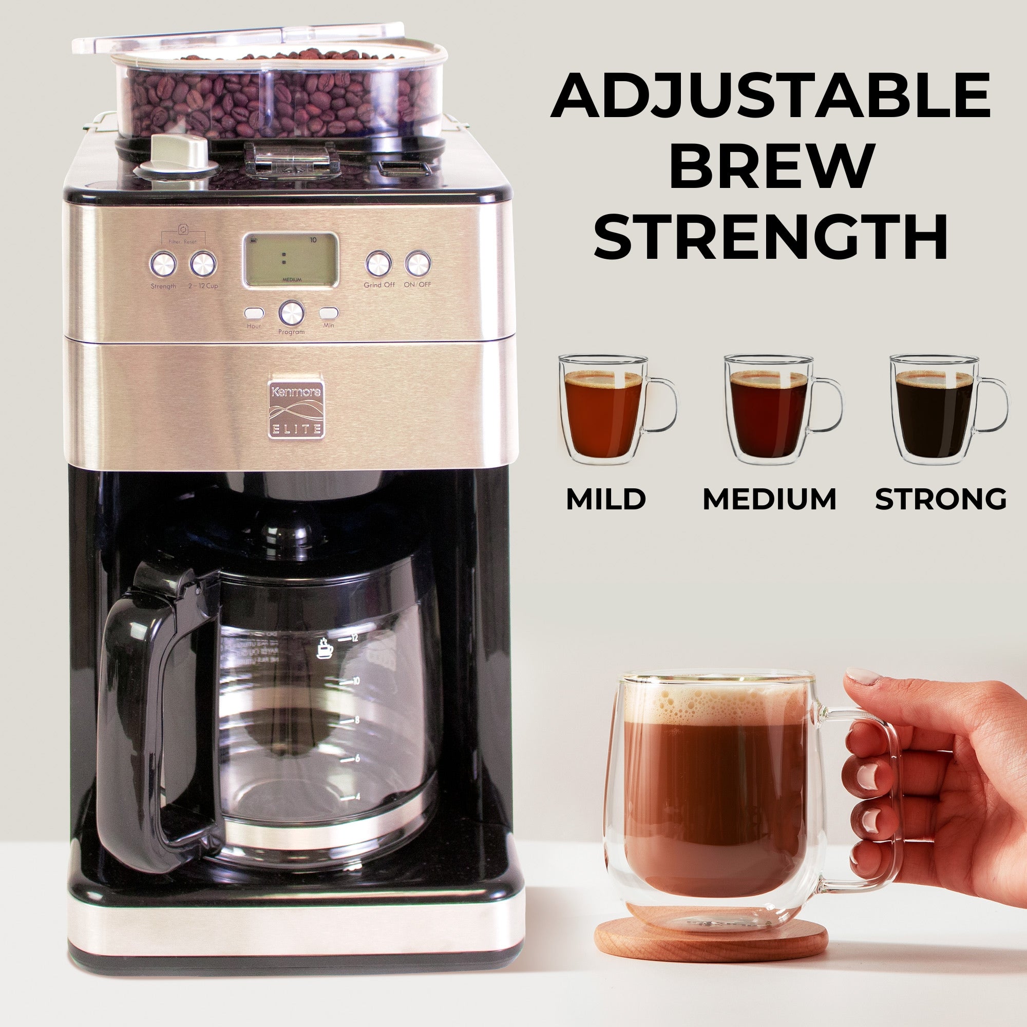 Enhanced image shows the Kenmore grind and brew coffee maker and a hand holding a clear glass mug of coffee. Above the mug are three drawings of clear mugs holding coffee of various strengths, labeled light, medium, and dark. Text above the drawings reads, "Customize brew strength"