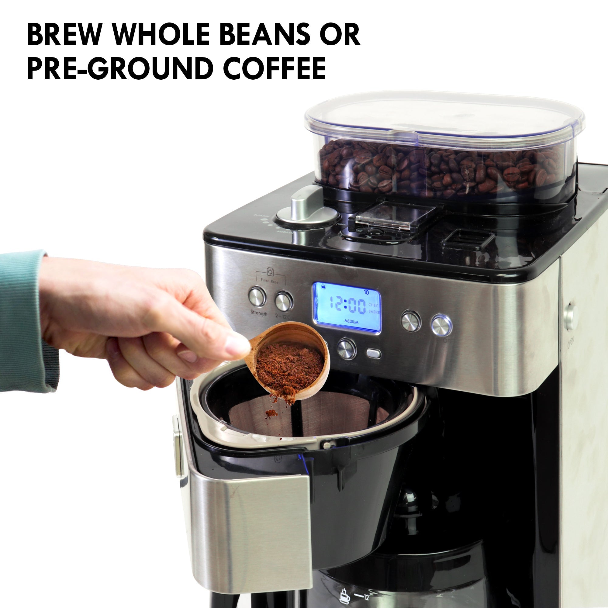 Lifestyle image of Kenmore grind and brew coffee maker on a white counter with white tile backsplash and a window with white blinds behind it and a person's hand pouring coffee from the glass carafe into a light blue mug in front. Text above reads, "Grind beans just before brewing for the freshest coffee and richest taste"