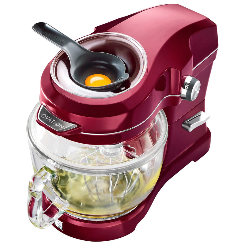 Product shot of red Elite Ovation tilt-head stand mixer on white background of mixer with egg separator containing egg in the pour-in top opening