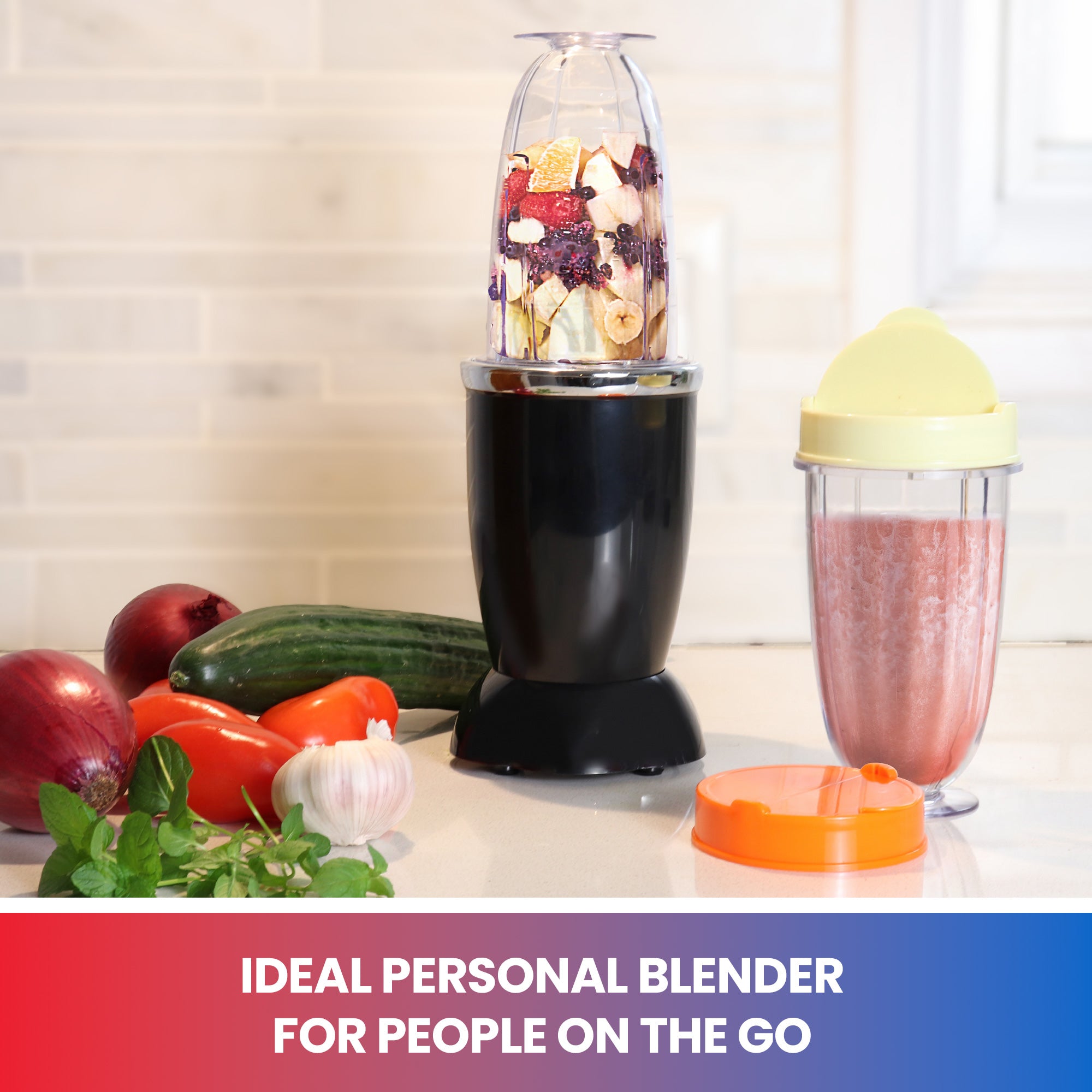 Lifestyle image of blender with travel cup filled with fruit on a white countertop with vegetables on the left and a travel cup of pink smoothie on the right. Text below reads "Ideal personal blender for people on the go"