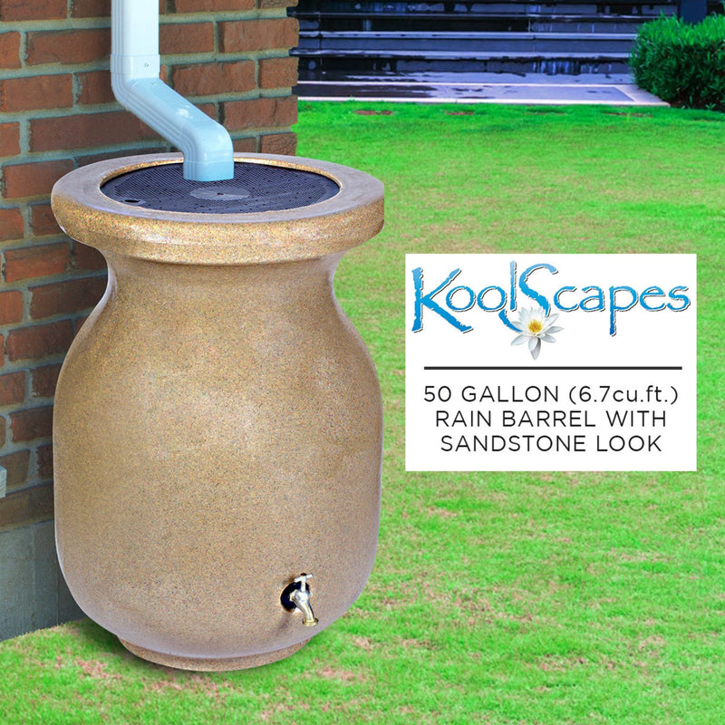 Lifestyle image of rain barrel set up on grass under a white downspout with a red brick wall in the background. Overlay to the right contains the Koolscapes logo and text reading, "50 gallon (6.7 cu. ft.) rain barrel with sandstone look"