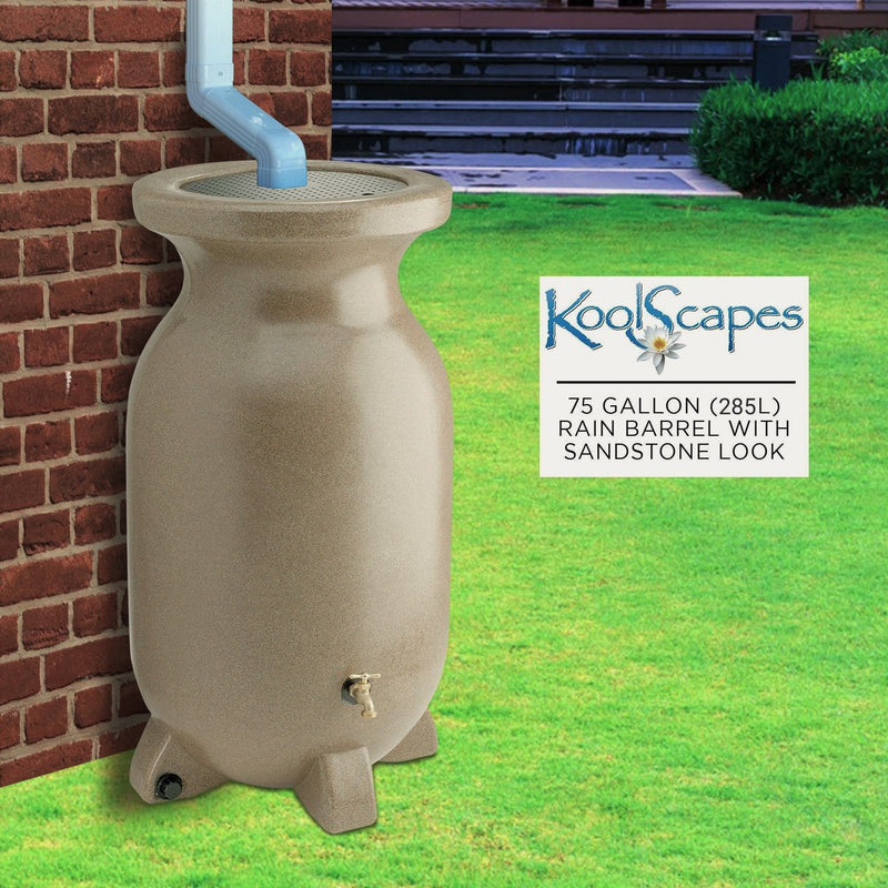 Lifestyle image of rain barrel set up on grass under a white downspout with a red brick wall in the background. Overlay to the right contains the Koolscapes logo and text reading, "75 gallon (285L) rain barrel with sandstone look"