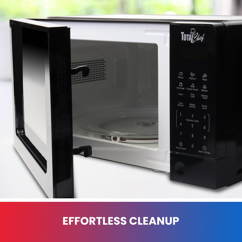 Lifestyle image of black microwave on a white countertop with door partially open and dishwasher-safe glass tray and roller ring visible inside. Text below reads, “Effortless cleanup”