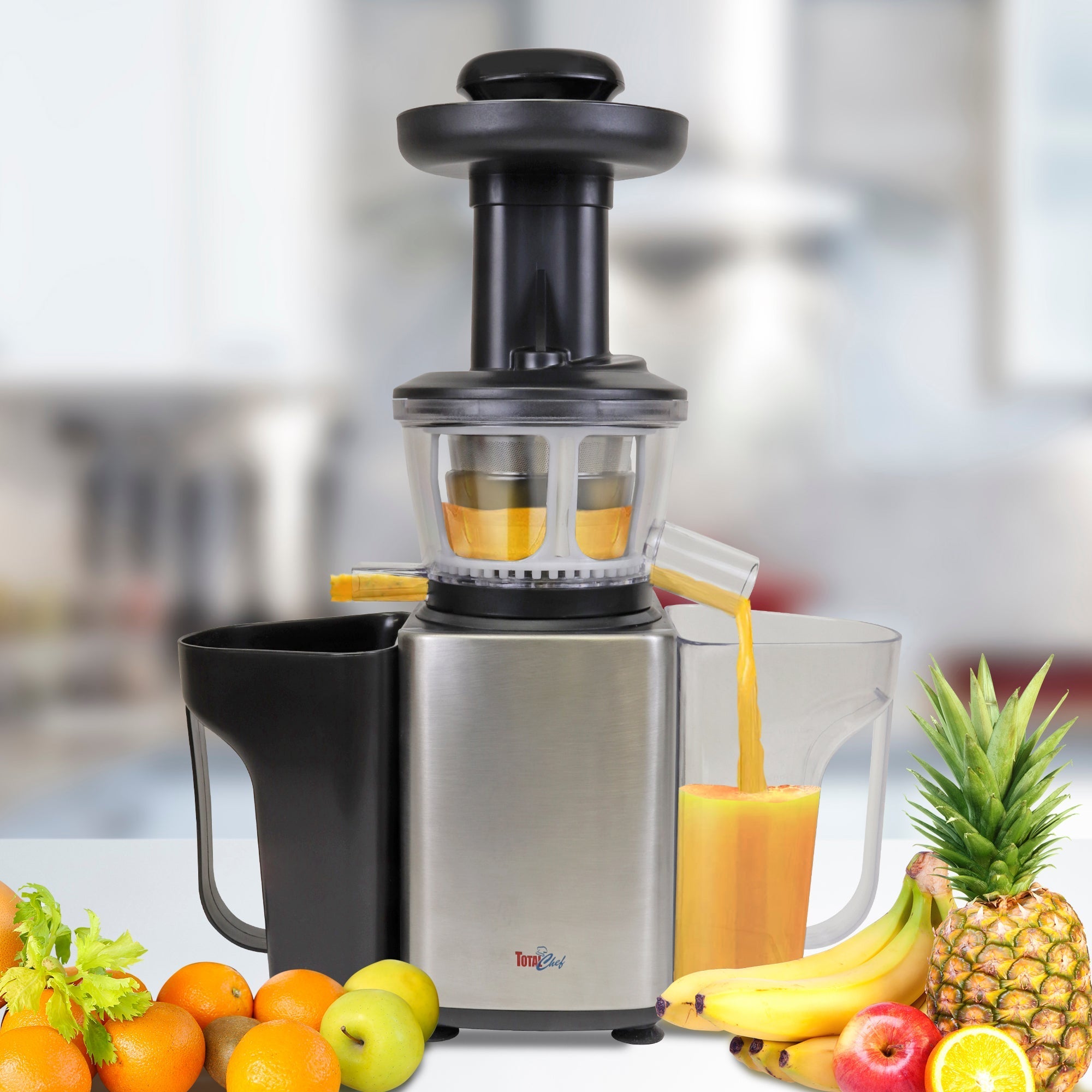 Lifestyle image of juicer in use with fruits and vegetables around it