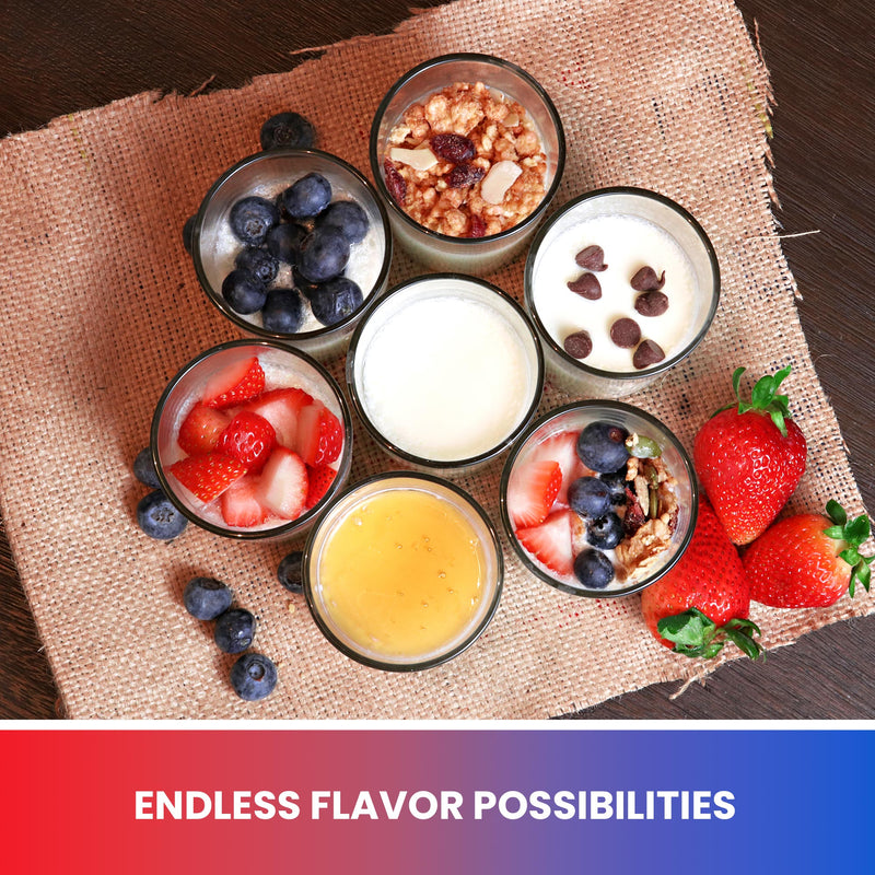Lifestyle image of 7 small ceramic containers of yogurt with various toppings (berries, granola, chocolate chips, honey) on a piece of burlap on a dark wooden table. Text below reads, "Endless flavor possibilities"
